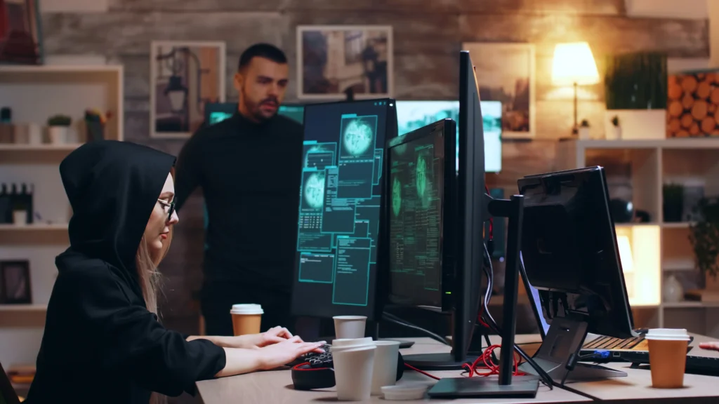 girl-hacker-wearing-glasses-hoodie-while-stealing-personal-data-with-her-team
